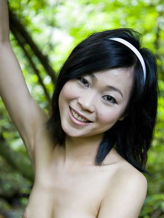 Asian teen Abbie Chan wanders thru a forest...